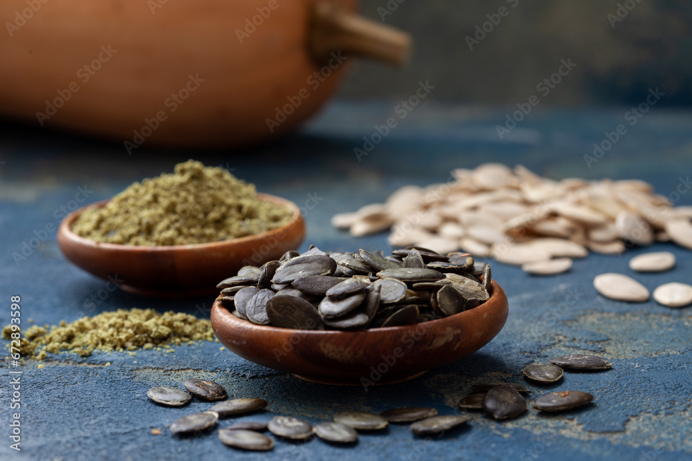 Peeled and grinded pumpkin seed in wooden bowls. Healthy, organic food full of vitamins and antioxidants, remedy for prostate problems. Peeled and grinded pumpkin seed in wooden bowls. Healthy, organic food full of vitamins and antioxidants, remedy for prostate problems.