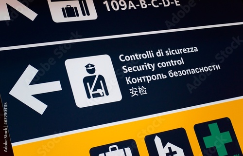 Security control at the airport, signboard in several languages. Public safety, airport signage concept.