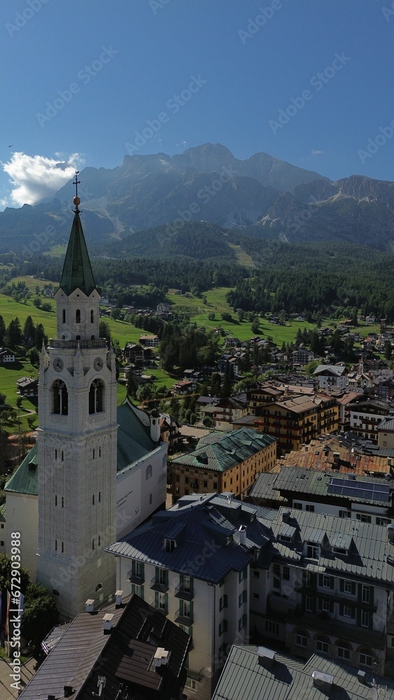 a church tower on a roof overlooking a large mountain range