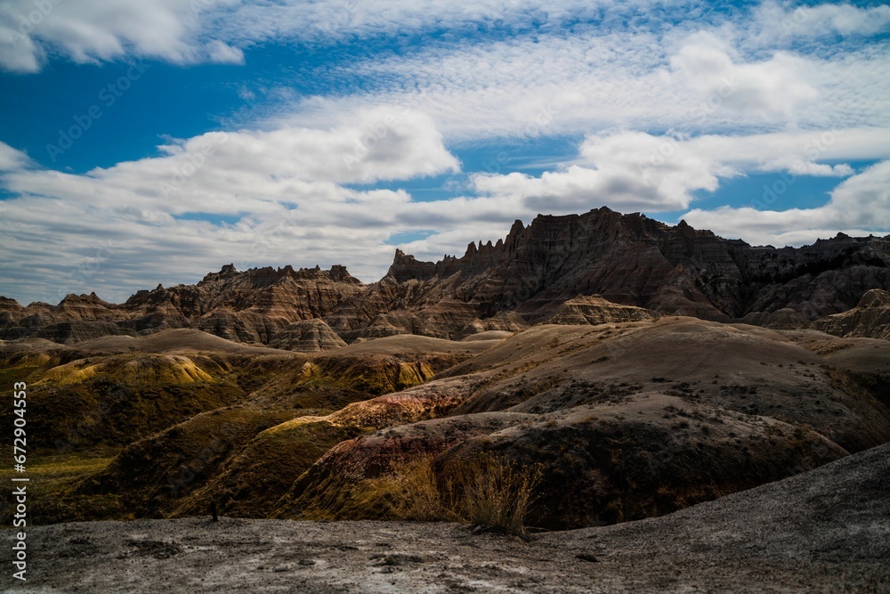 Landscape of hills under a cloudy sky in Badlands National Park, South Dakota