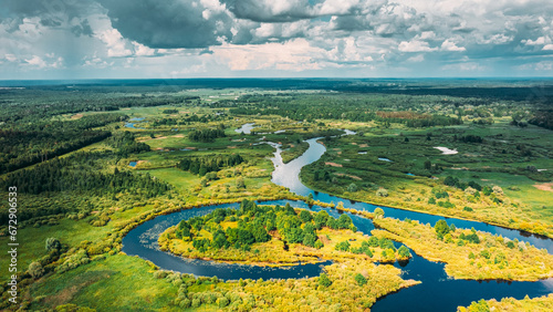 Drone Aerial View Spring Forest Woods And Curved River Marsh. Springtime Landscape. Top View From High Attitude In Summer Season. Drone View, . Bird's Eye View. River Eco Water Concept Background.