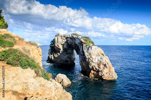 Rock arch called Es Pontas on the south coast of Mallorca on a summer day