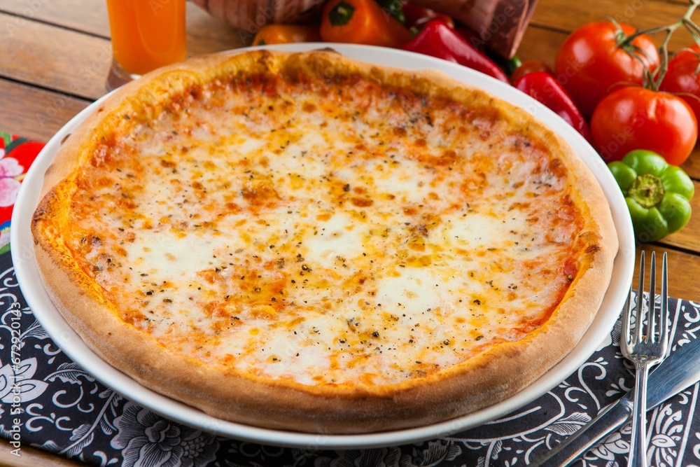 Closeup of a delicious fresh cheese pizza on the table