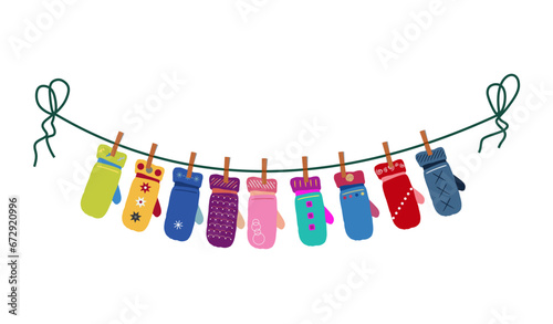 Different mittens hanging on the rope. Wool winter gloves mittens dry and hang on laundry string with clothespins. © Ox_art