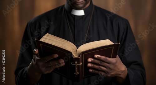 Pastor with a Bible in his hand during a sermon. The preacher delivers a speech. Senior priest standing with Bible photo