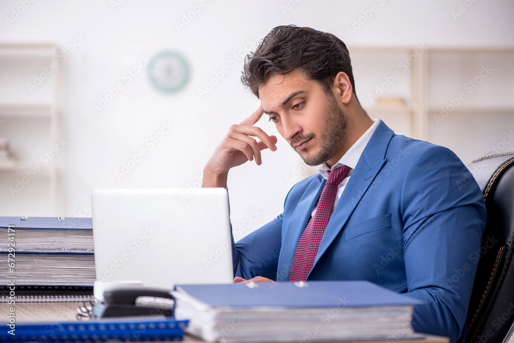 Young male employee working in the office Young male employee working in the office