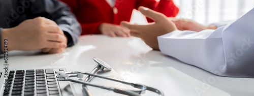 Couple attend fertility consultation with gynecologist at hospital as part family planning care for pregnancy. Loving husband and wife support each other through the doctor appointment. Panorama Rigid