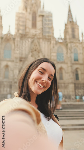 Traveler girl taking selfie on mobile phone at the old building in the historical part of the old European city background