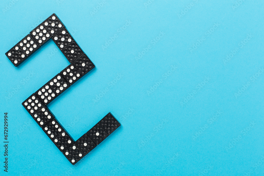 Black domino tiles on color background, top view Black domino tiles on color background, top view