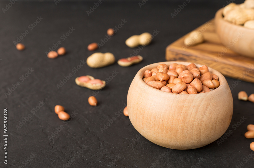 Peeled and unpeeled peanuts on concrete table Peeled and unpeeled peanuts on concrete table