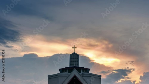 Mysterious polar cloud iridescence phenomenon glowing over christian church and cross shape religious photo