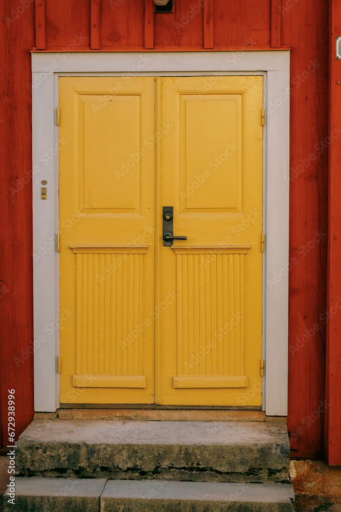 An artsy old yellow wooden door