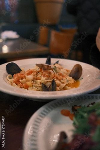 a meal consisting of shrimp, clams and pasta with meat
