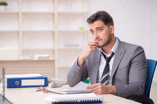 Young male employee working in the office