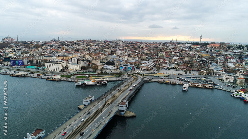 aerial view of Galata Bridge overlooking Bosphorus and city. Movement of cars, boats and ships. Istanbul, Turkey. 