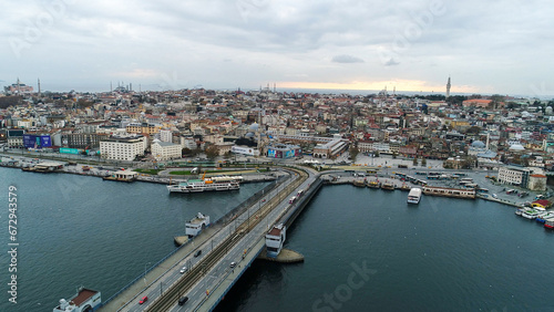 aerial view of Galata Bridge overlooking Bosphorus and city. Movement of cars, boats and ships. Istanbul, Turkey. 
