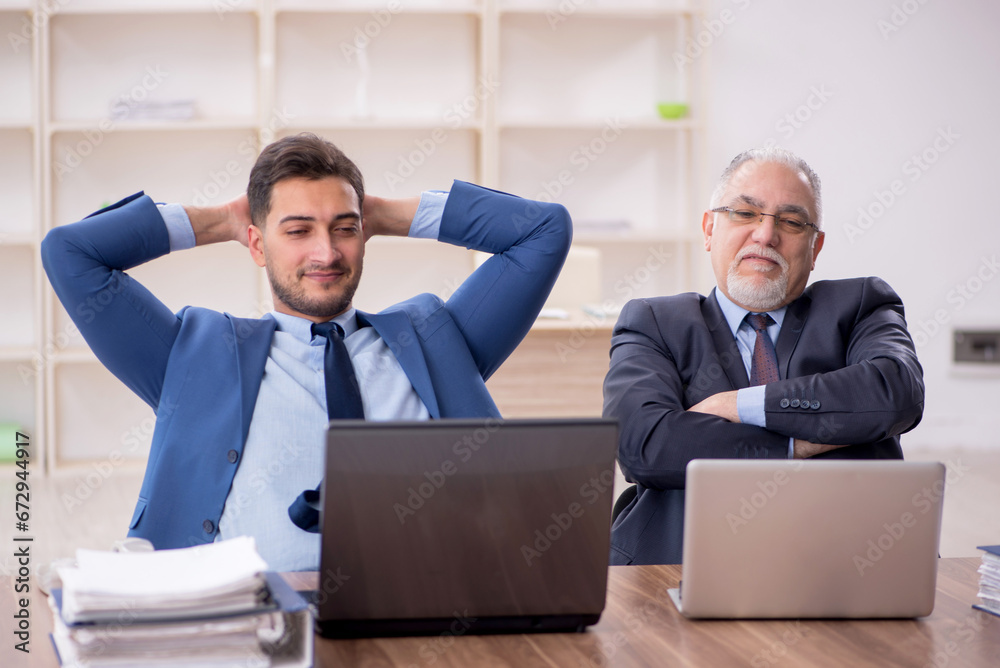 Two male employees working in the office Two male employees working in the office