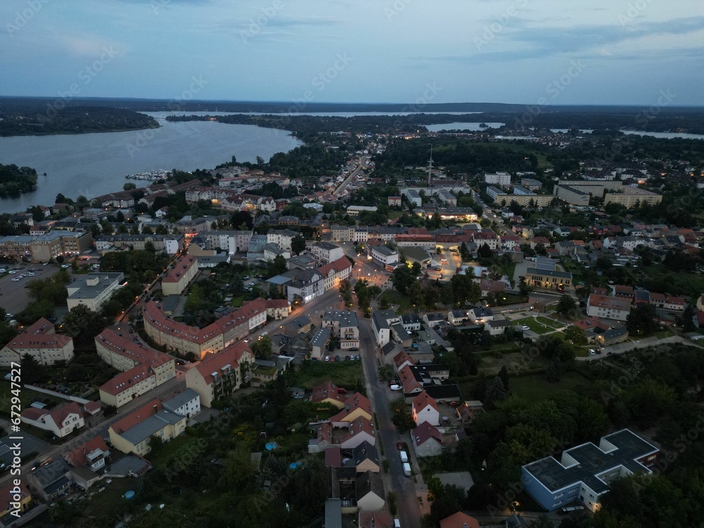 Fototapeta premium Aerial view of residential houses along a river at twilight