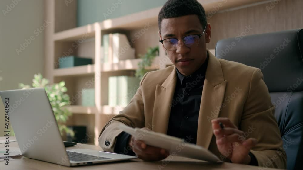 Business man African American accountant male office worker write financial data analysis plan strategy focused businessman work with laptop computer manage project study paper report signing document