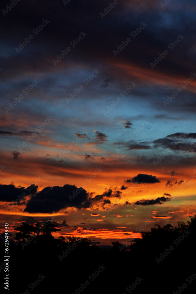 Beautiful sky on twilight time. Cloudy rose blue sunset over dark silhouettes of trees in nature. Real amazing panoramic sunrise or sunset sky with hot-tempered and vehement clouds. Beautiful sky on twilight time. Cloudy rose blue sunset over dark silhouettes of trees in nature. Real amazing panoramic sunrise or sunset sky with hot-tempered and vehement clouds.