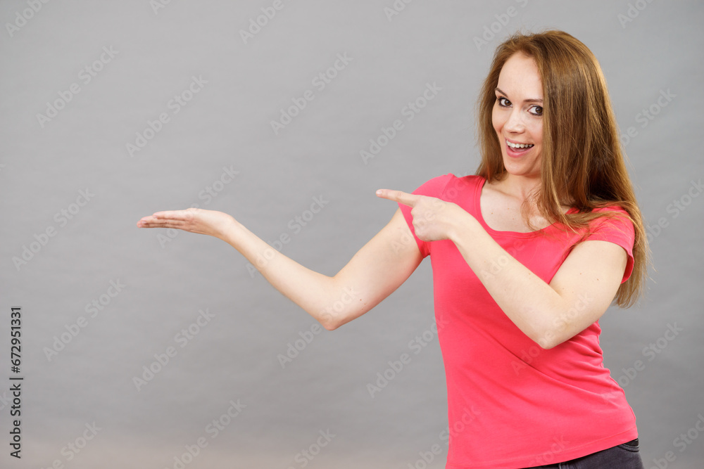 Woman points to open empty hand Woman points to open empty hand