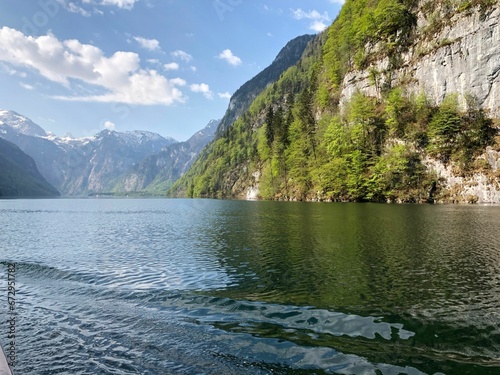 Fototapeta Naklejka Na Ścianę i Meble -  Tranquil Lake Konigssee surrounded by majestic mountain range on a sunny day