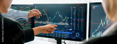 Group of skilled investor discuss about stock investment. Businesspeople look at stock charts before making investment decisions. Stock market trading concept. Cropped image. Closeup. Burgeoning. photo
