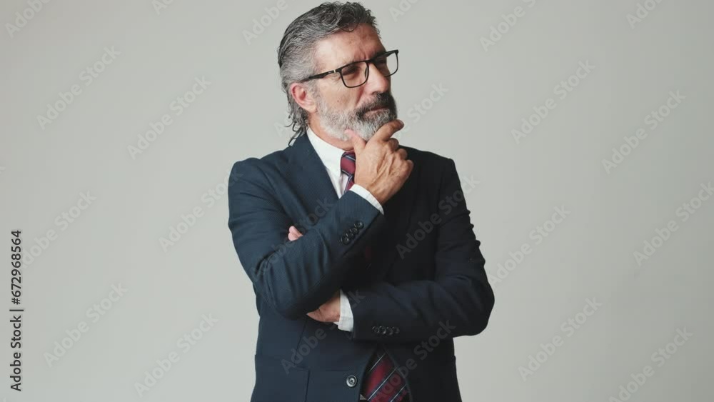 Middle aged businessman hand props chin, isolated on gray background Middle aged businessman hand props chin, isolated on gray background