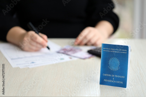 Brazilian work card and social security blue book lies on accountant or boss table close up photo