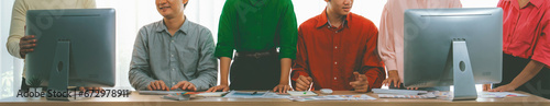 A cropped image of business group discuss about financial plan at meeting room. Successful business people brainstorm marketing idea with document and laptop placed on table. Front view. Variegated.