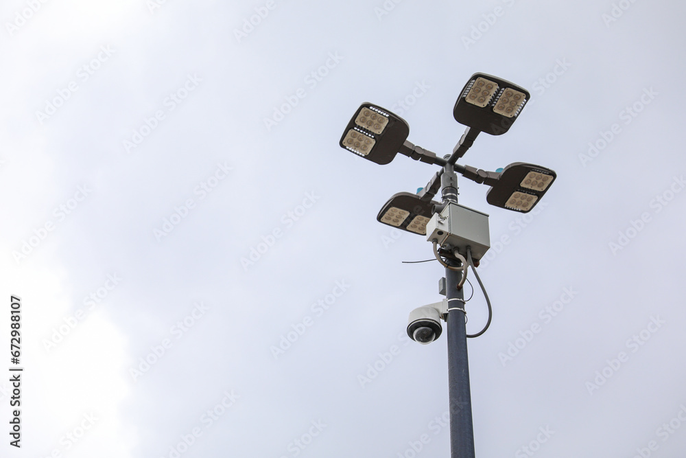 surveillance camera on a city street, symbolizing security and monitoring, framed against an urban backdrop with a neutral tone surveillance camera on a city street, symbolizing security and monitoring, framed against an urban backdrop with a neutral tone