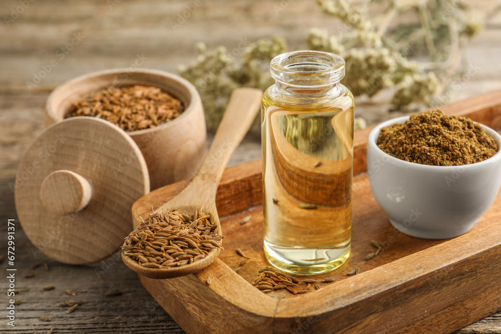 Caraway (Persian cumin) seeds, powder and essential oil on table, closeup Caraway (Persian cumin) seeds, powder and essential oil on table, closeup