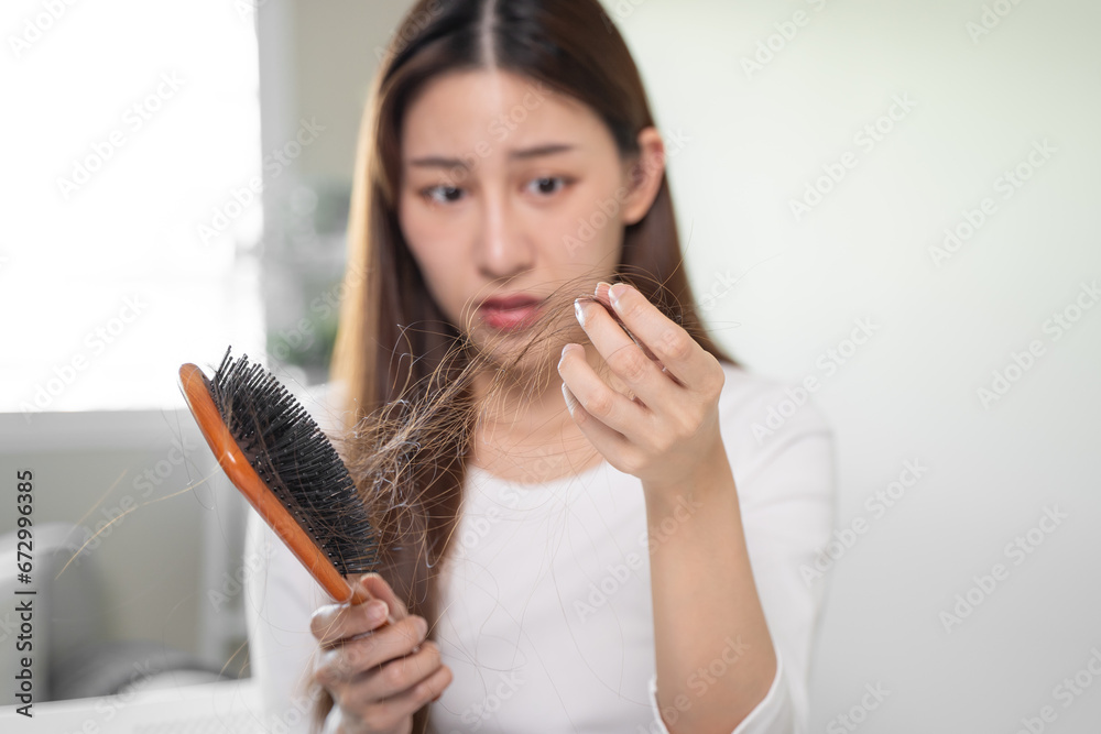 Hair loss problem, Asian woman look at scalp worry about balding. Hair loss problem, Asian woman look at scalp worry about balding.