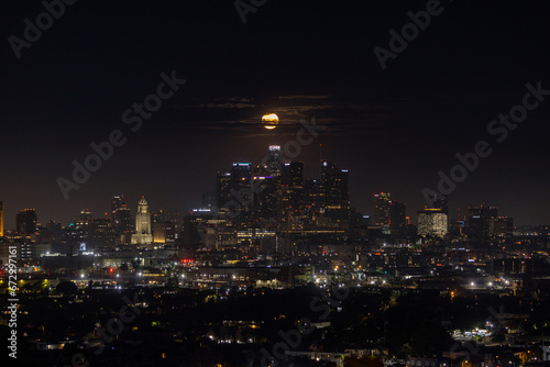 The full moon setting behind downtown Los Angeles