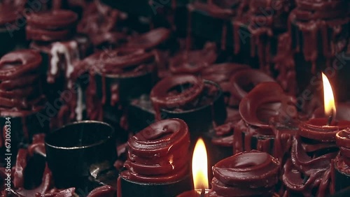 Ambient motion of dying flames among the melted candle offerings or halad for a catholic religious practice during Undas, Kalag kalag or All Souls Day in the Philippines photo