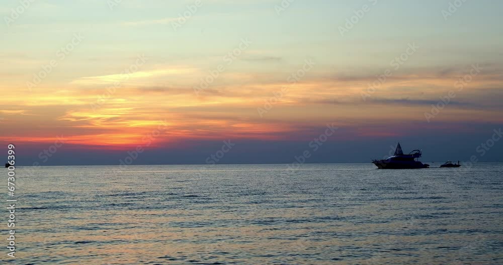 Twilight seascape scene with the silhouettes of three boats, a cruiser, sailboat and fishing boat on the water and clouds above the horizon. Twilight seascape scene with the silhouettes of three boats, a cruiser, sailboat and fishing boat on the water and clouds above the horizon.