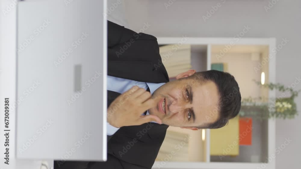 Vertical video of Home office worker man biting his nails looking at camera. Vertical video of Home office worker man biting his nails looking at camera.