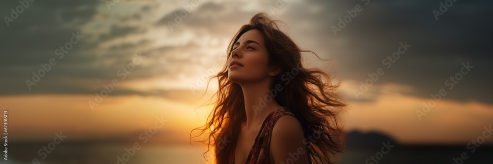 Caucasian woman looking at sunset sky