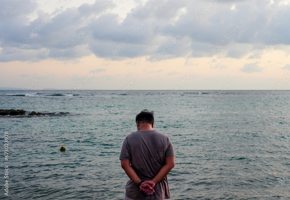 Rear view of a man contemplating on the beachRear view of a man contemplating on the beach Rear view of a man contemplating on the beachRear view of a man contemplating on the beach