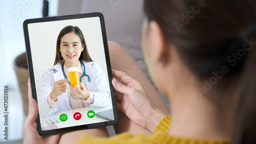 Asian woman patient make video call counseling doctor about healthcare by digital tablet, Telemedicine, Pharmacist