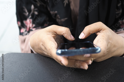 close up of women hand holding smart phone 