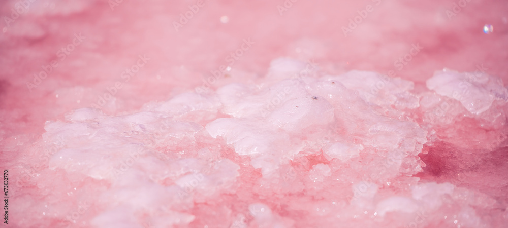 Pink salt crystals. Natural pink salt lake texture. Salt mining. Extremely salty pink lake, colored by microalgae with crystalline salt depositions Pink salt crystals. Natural pink salt lake texture. Salt mining. Extremely salty pink lake, colored by microalgae with crystalline salt depositions