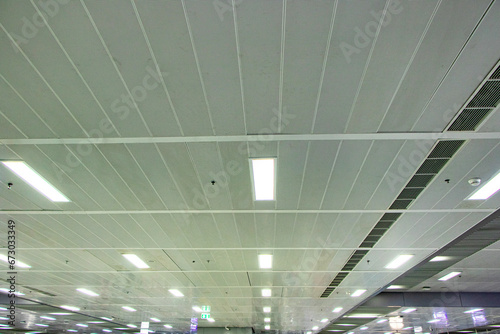 Ceiling with light bulbs lighting with ventilation pipes in train station in Thailand. Most popular ceiling panels today. Modern design. Ceiling is important component of house that enhances beauty.