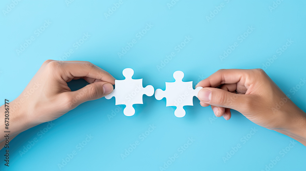 Concept of business,hands holding a jigsaw puzzle on pastel blue background Concept of business,hands holding a jigsaw puzzle on pastel blue background