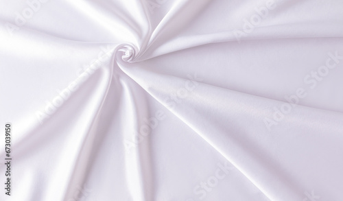 White wedding abstract satin background. Folds of fabric in a spiral pattern. Design, layout, template.