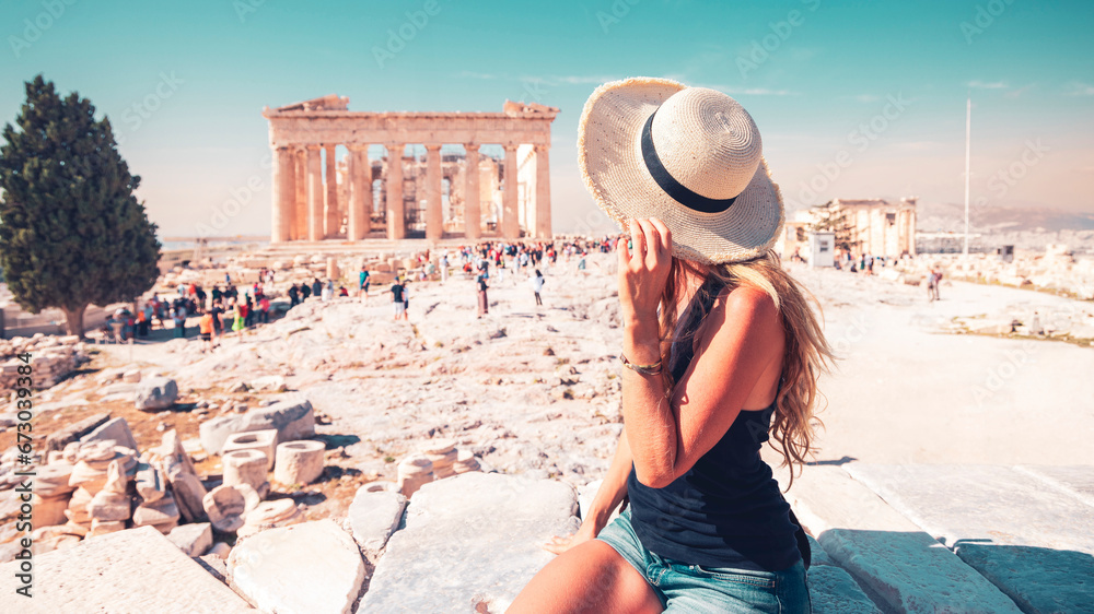 Young female tourist looking at the Parthenon, Acropolis in Athens- travel, tour tourism in Greece
