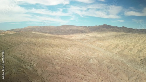 High wide aerial above dry Mojave Desert by Lake Mead in northern Arizona
