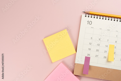 close up of calendar on the colorful pink table background, planning for business meeting or travel planning concept photo