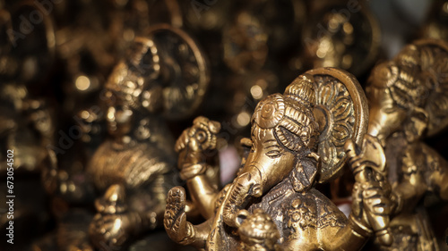 an antique idol of hindu god ganesha carved on stone in vintage gift shop for handcrafted statues and objects