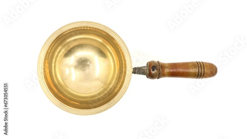 top view of a vintage golden brass diya oil lamp or vilakku with handle traditionally used for pooja rituals in temples of india isolated in a white background